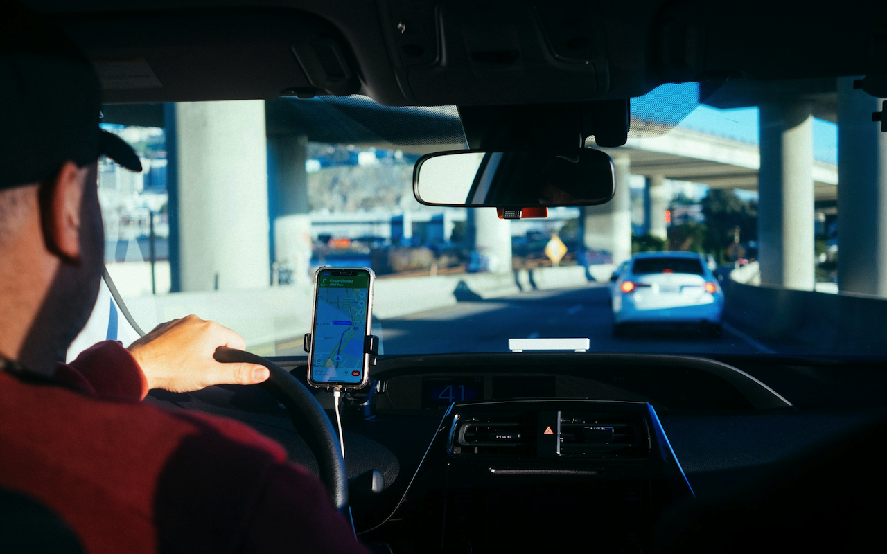 A person driving with a map on iPhone